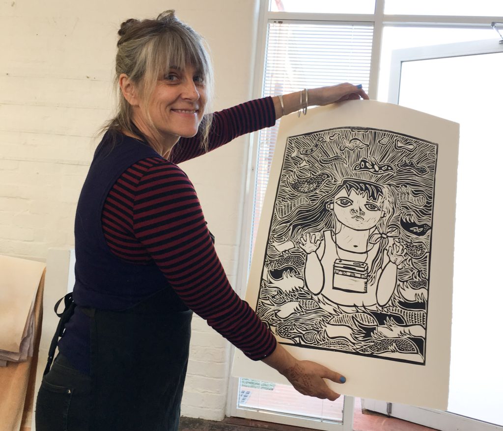 Irene holding a print